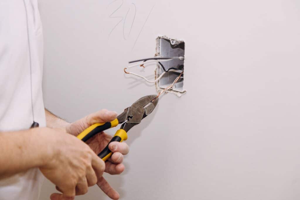 Electrical wiring technician wall outlet