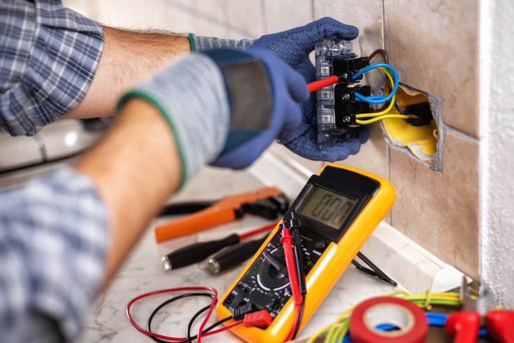 Low voltage technician working on outlet