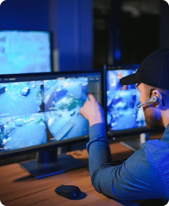 worker monitoring surveillance cameras on a computer monitor