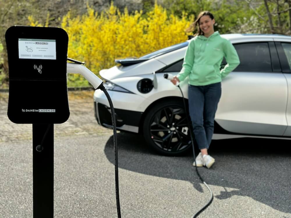 person charging electric vehicle